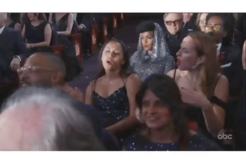 The audience reacts to Eminem's performance at the Oscars.