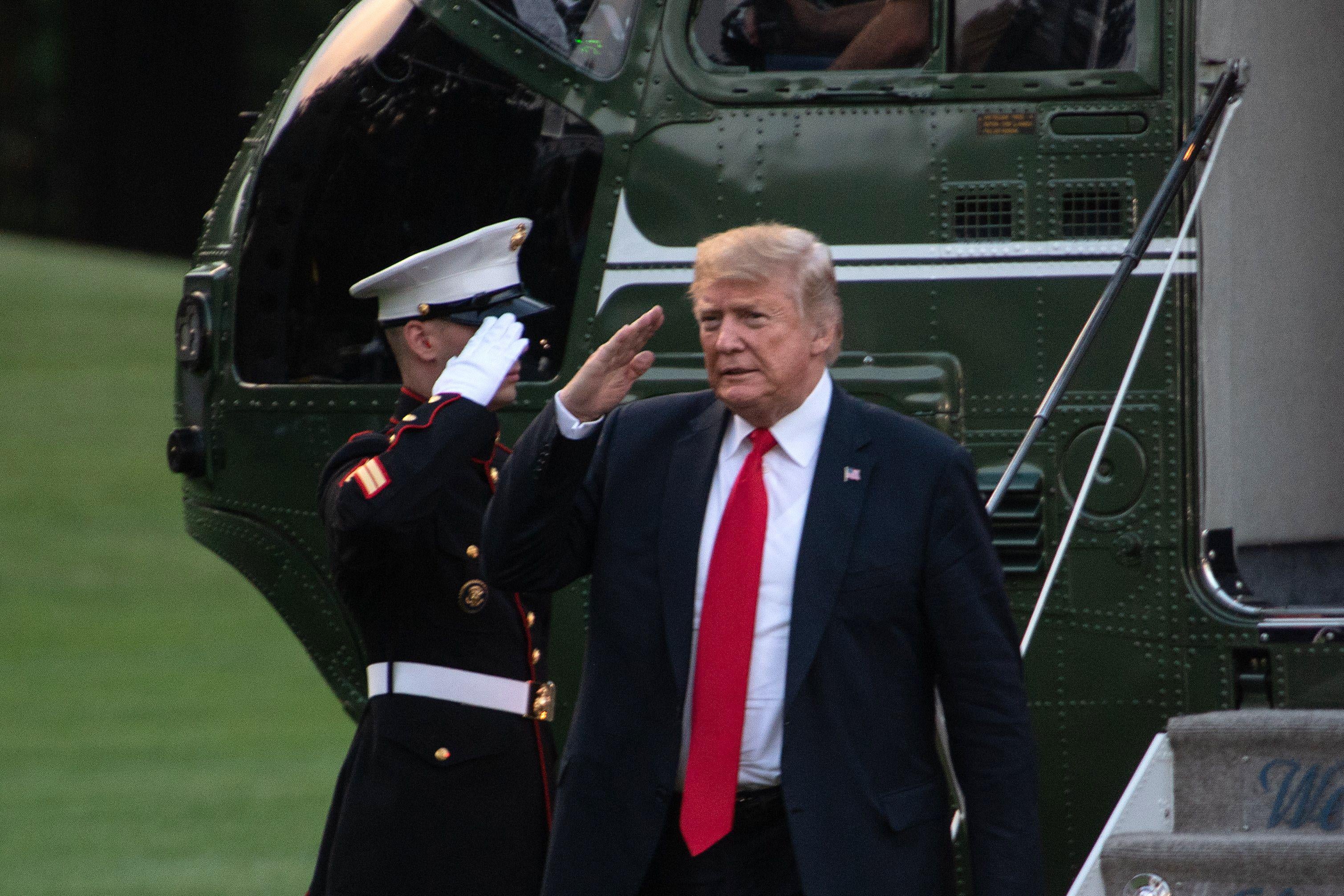 President Donald Trump salutes upon his return to the White House in Washington, D.C., on July 26, 2018. 