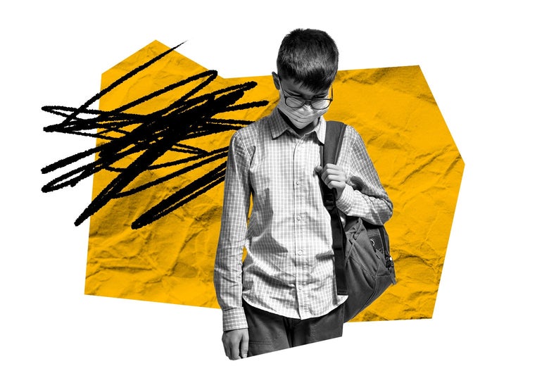 A boy wearing a backpack hangs his head in disappointment.