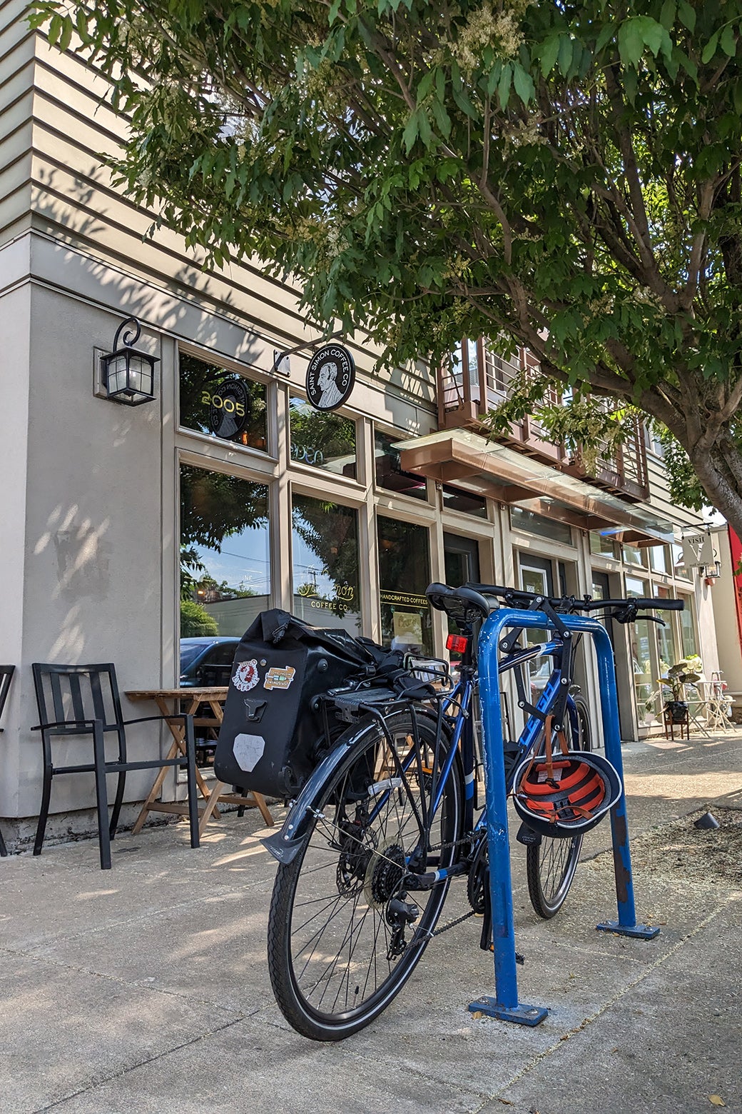 A bike is in a bike rack on a charming city street. 