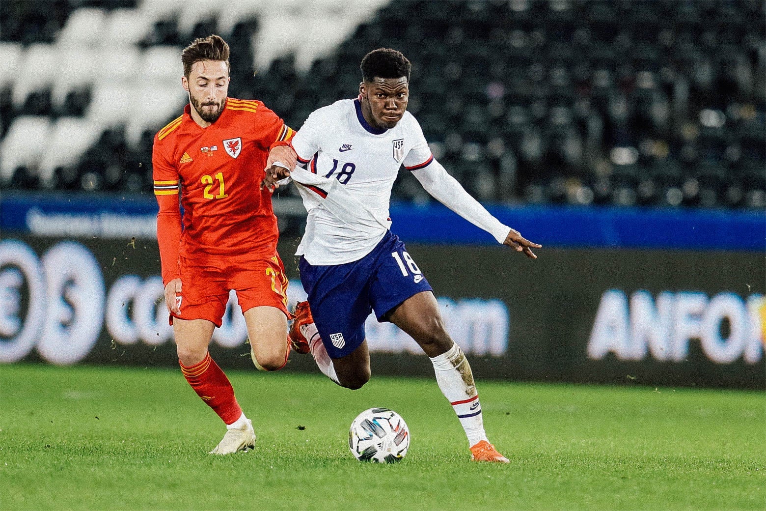 Yunus Musah dribbles a soccer ball in a game against Wales.