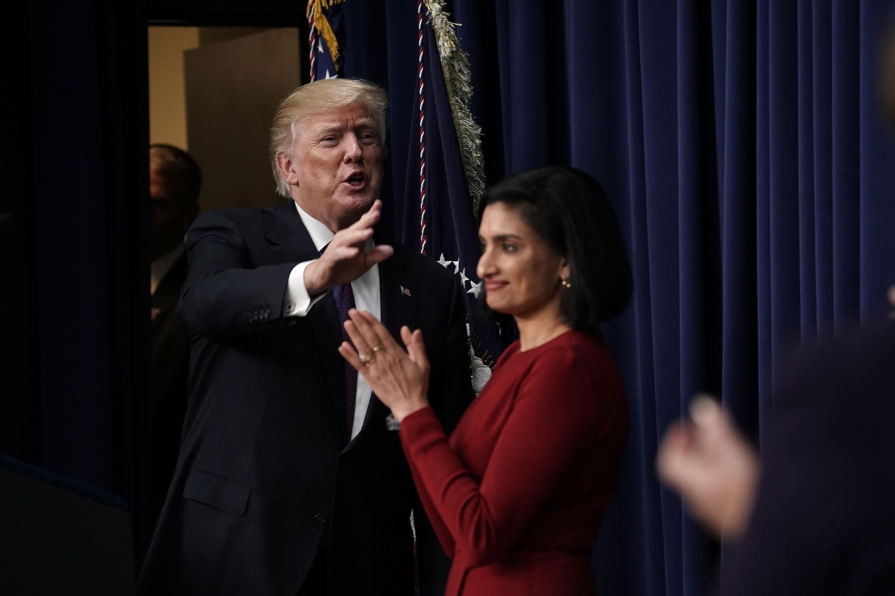 WASHINGTON, DC - JANUARY 16:  U.S. President Donald Trump (L) acknowledges the audience as Administrator of the Centers for Medicare and Medicaid Services Seema Verma (R) looks on as he stops by a Conversations with the Women of America panel at the South Court Auditorium of Eisenhower Executive Office Building January 18, 2018 in Washington, DC. The three-part panel features ÒAmerican women from various backgrounds and experiences who will speak with high-level women within the Trump Administration, about what has been accomplished to date to advance women at home, and in the workplace.Ó (Photo by Alex Wong/Getty Images)