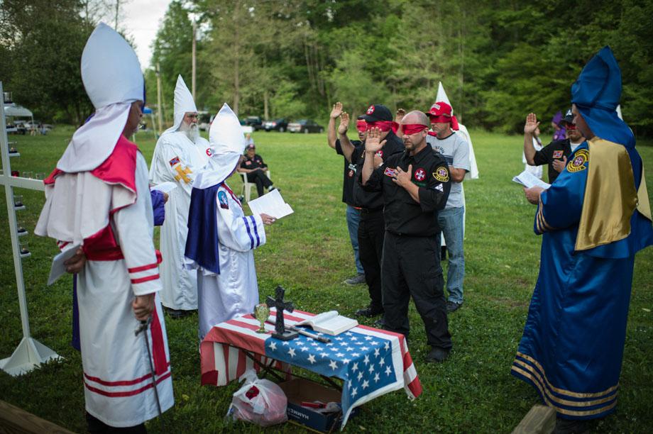 Canidates wishing to become initiated into the Ku Klos Knights of the Ku Klux Klan take their oaths as part of a the naturalization ritual.Naturalization is becoming a citizen of the Invisible Empire, and not unlike becoming a Naturalized citizen of the United States", according to a comment made by the late Imperial Wizard Dale Fox. “There are some parts of the ceremony that many might at first mistake for a "hazing". Proposed Klansmen are blindfolded, and then with one arm placed on the shoulder of the man before him, led through the woods at a sometimes-vigorous pace. The link is not to be broken as they are questioned and intimidated occasionally with the sound of a firearm.This "hazing" actually has symbolic purpose, and builds mutual trust, loyalty and reveals personal bravery and dedication. Candidates are brought before the Klan for acceptance into the Invisible Empire and are quizzed on their Klan craft and Klan history. They are instructed in the history of the six eras of the Klan. They participate in swearing certain oaths and at the conclusion they are "Knighted" as in the days of old, by anointing with sacred waters and a sword touch on both shoulders followed by a benediction. Finally, the new citizens of the Invisible Empire are greeted and welcomed by the officiating officers. Tennessee.