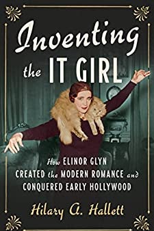 A cover of Inventing the It Girl, with a woman in a fur holding out her arms. 