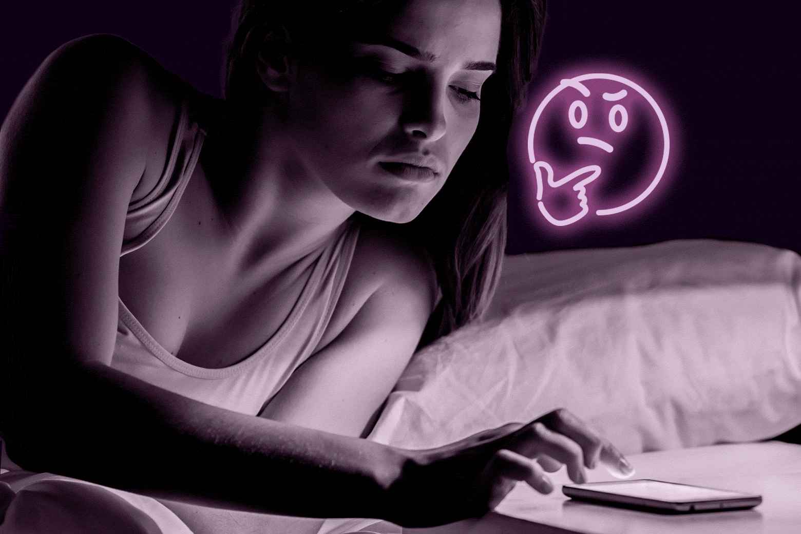 Woman in bed, typing on her phone on her nightstand.