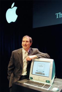 Steve Jobs posing with Apple Computer's iMac.