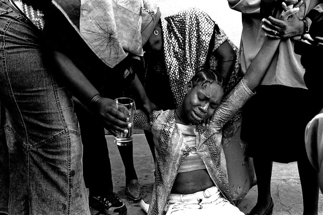 Soweto, Gauteng, November 2003Friends and relative comfort Lebohang Mokoena, Sibongile’s aunt, at the Kliptown Community Hall. Lebohang was looking after Sibongile when she went missing.