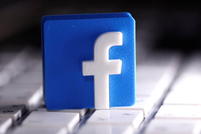 The Facebook logo is seen on a keyboard.