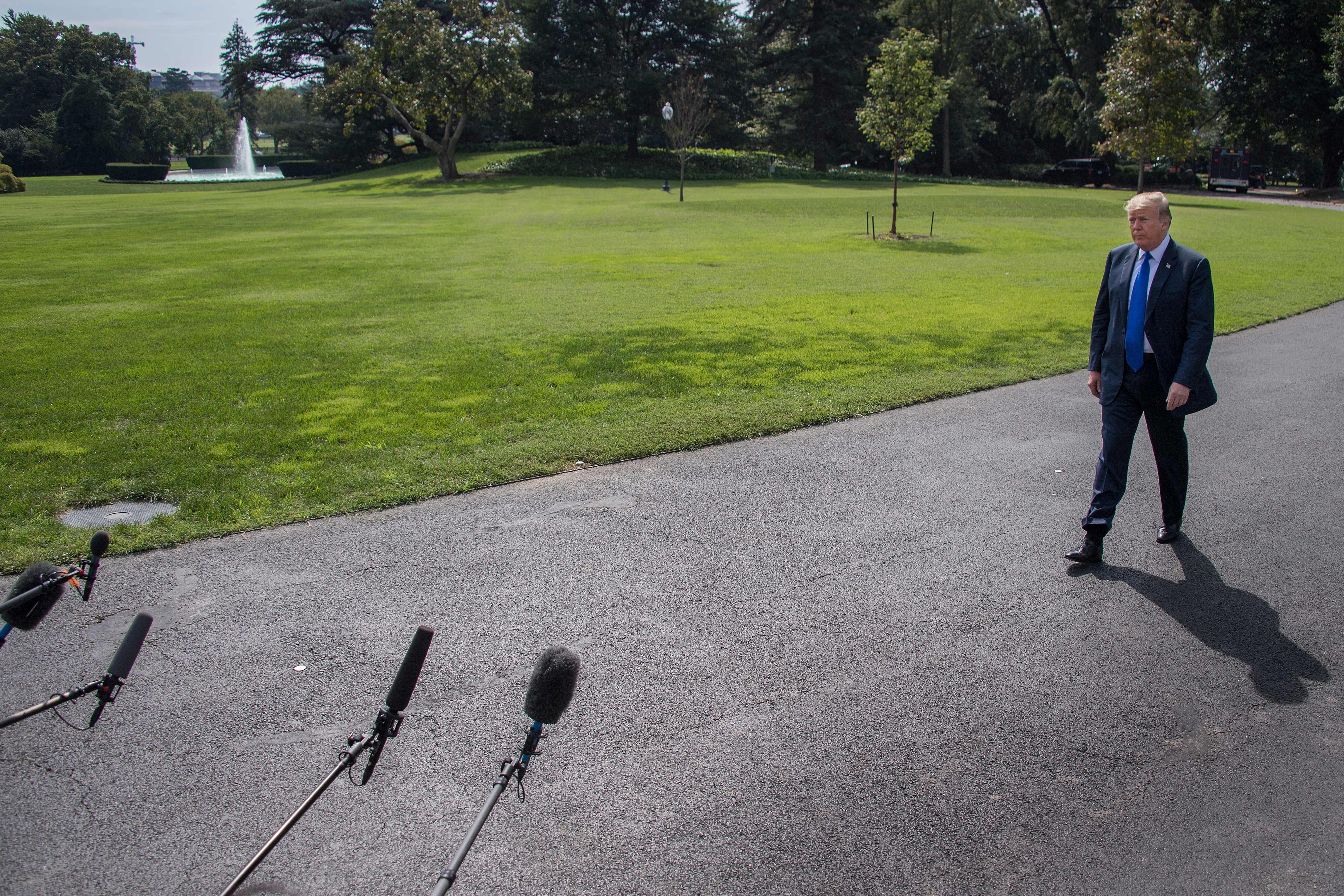 President Donald Trump approaching microphones at the White House on Tuesday.