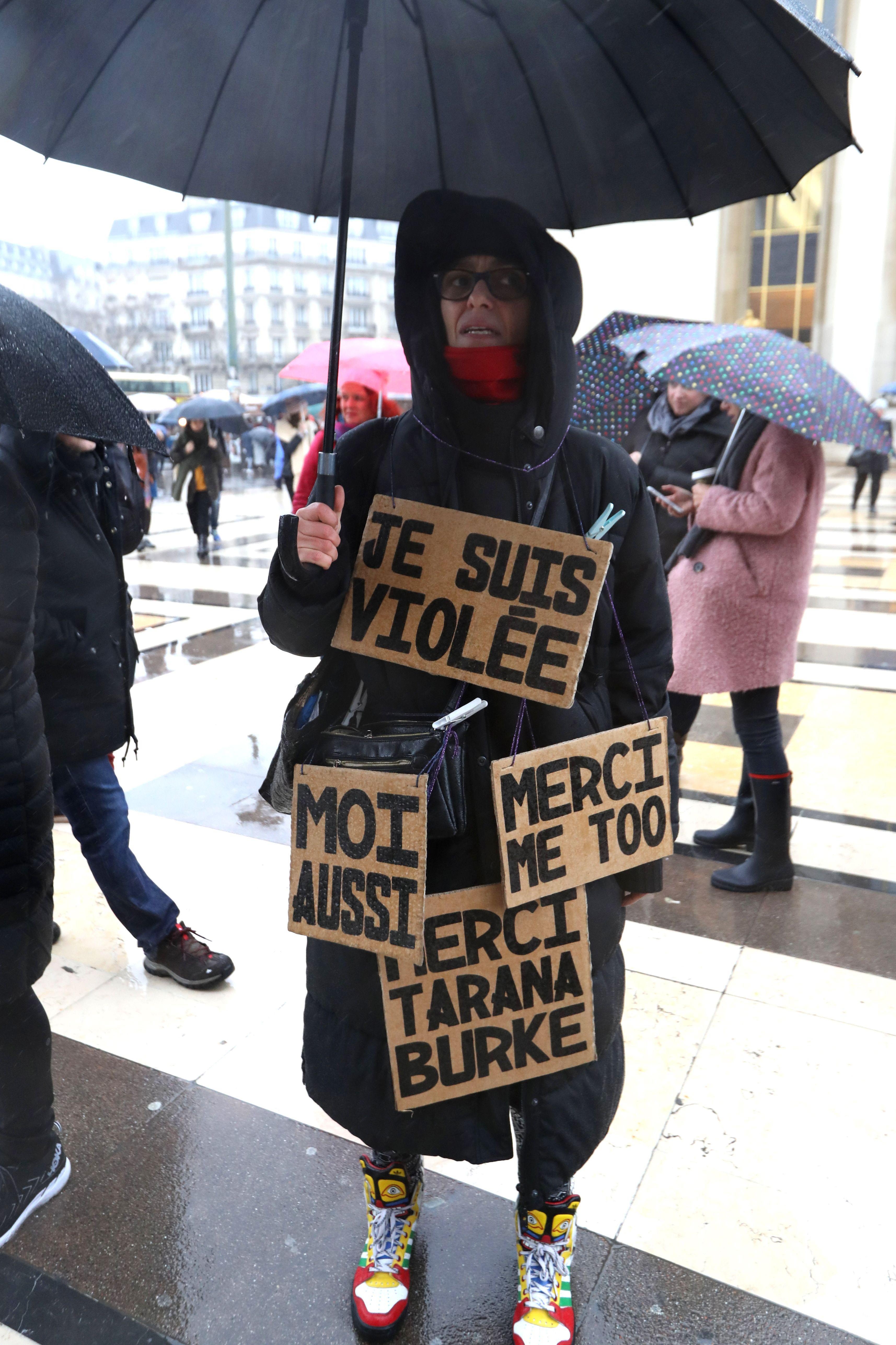 A demonstator bears signs reading 'I am raped. Thank you. Me too' on the Trocadero esplanade in Paris on January 21, 2018 during a women's march organized as part of a global day of protests, a year to the day since Donald Trump took office as US president.?Women's March organisers stage protests in a number of cities across Europe amid the #MeToo campaign against sexual harassment, a day after the first anniversary of the inauguration of US President.