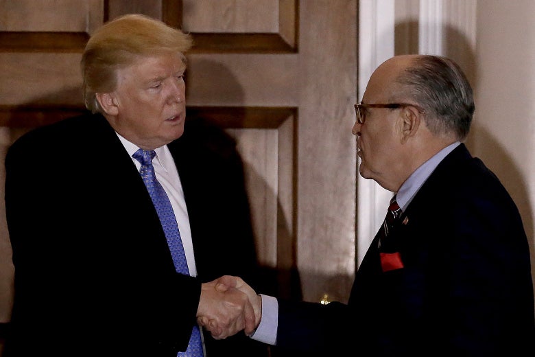 Rudy Giuliani shakes hands with Donald Trump at the clubhouse of Trump International Golf Club in Bedminster Township, New Jersey on Nov. 20, 2016.
