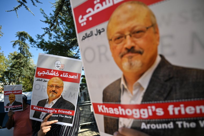 People carry signs bearing Jamal Khashoggi's face.