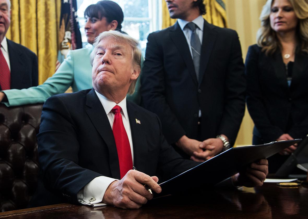 US President Donald Trump reacts after signing an executive order with small business leaders in the Oval Office at the White House in Washington, DC on January 30, 2017. 