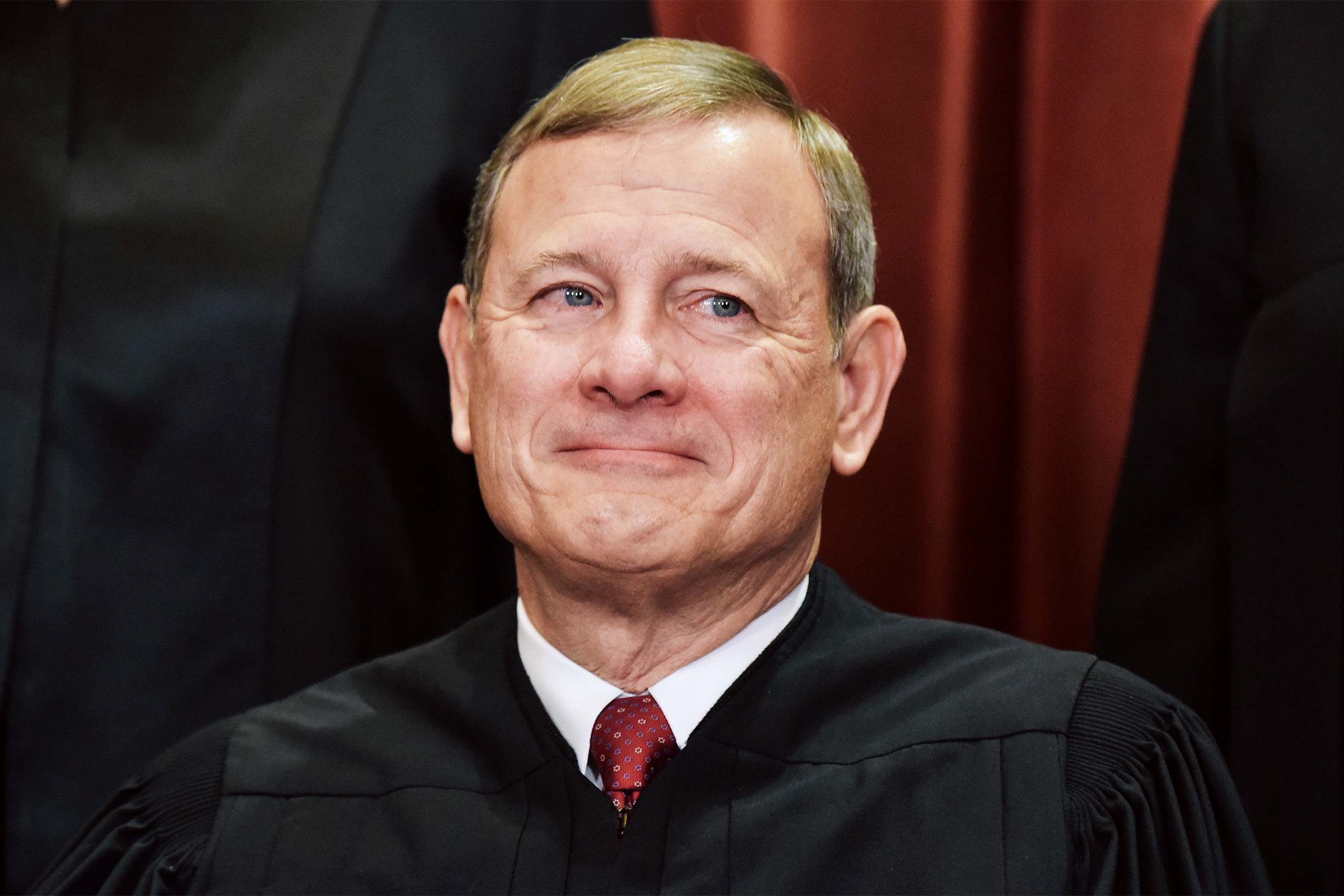 Chief Justice John Roberts poses for the official group photo at the U.S. Supreme Court in Washington on Nov. 30