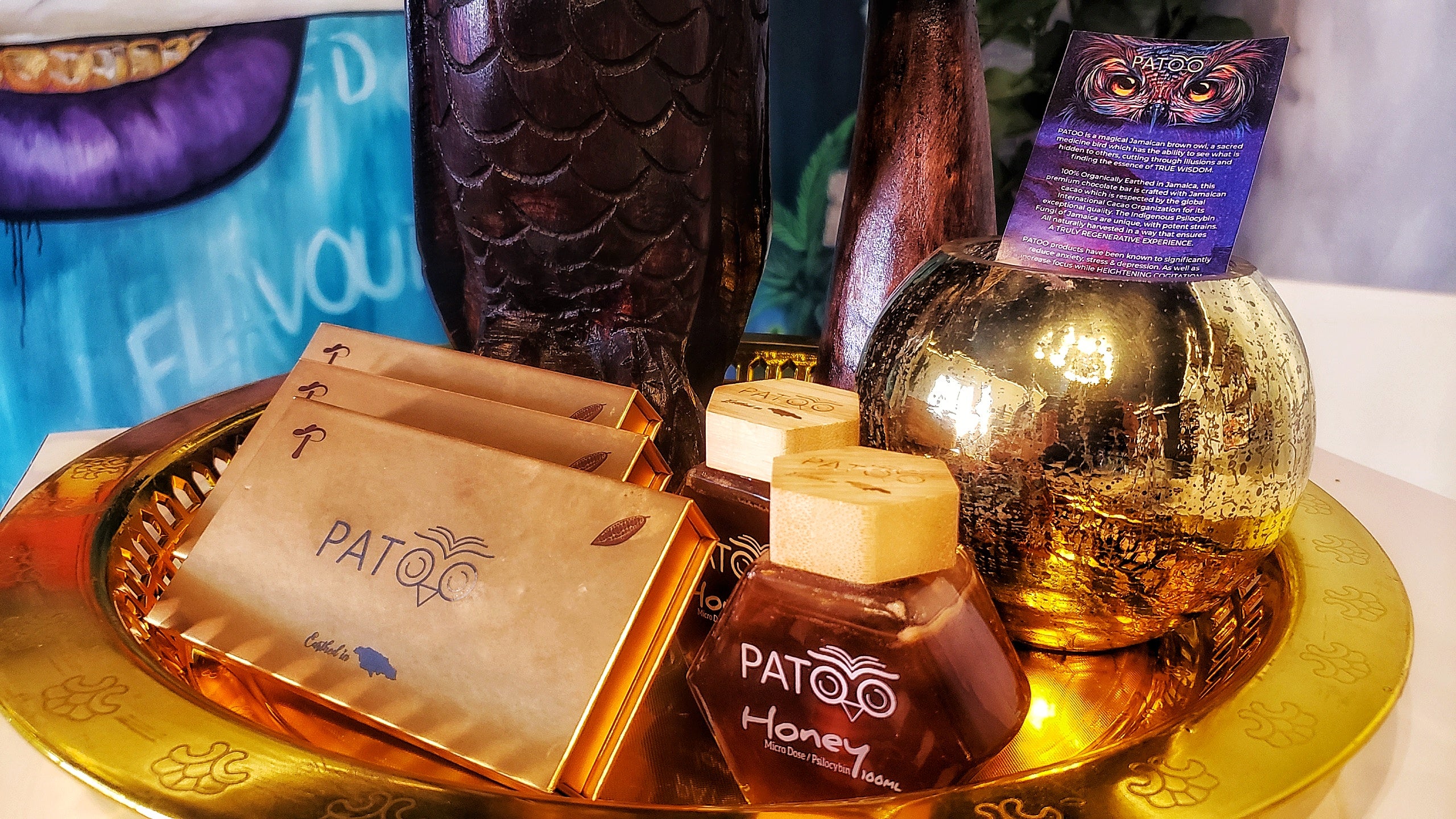 Patoo products in gold wrappers are arrayed on a gold tray. 