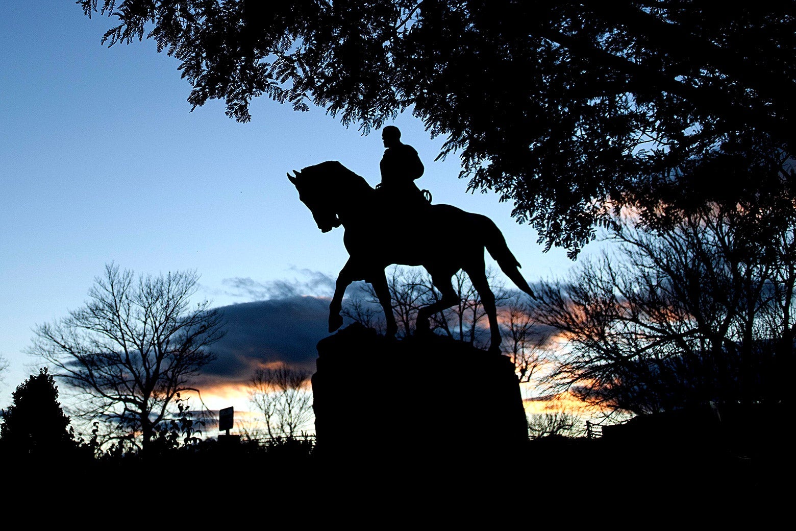 Silhouette of the statue at dusk
