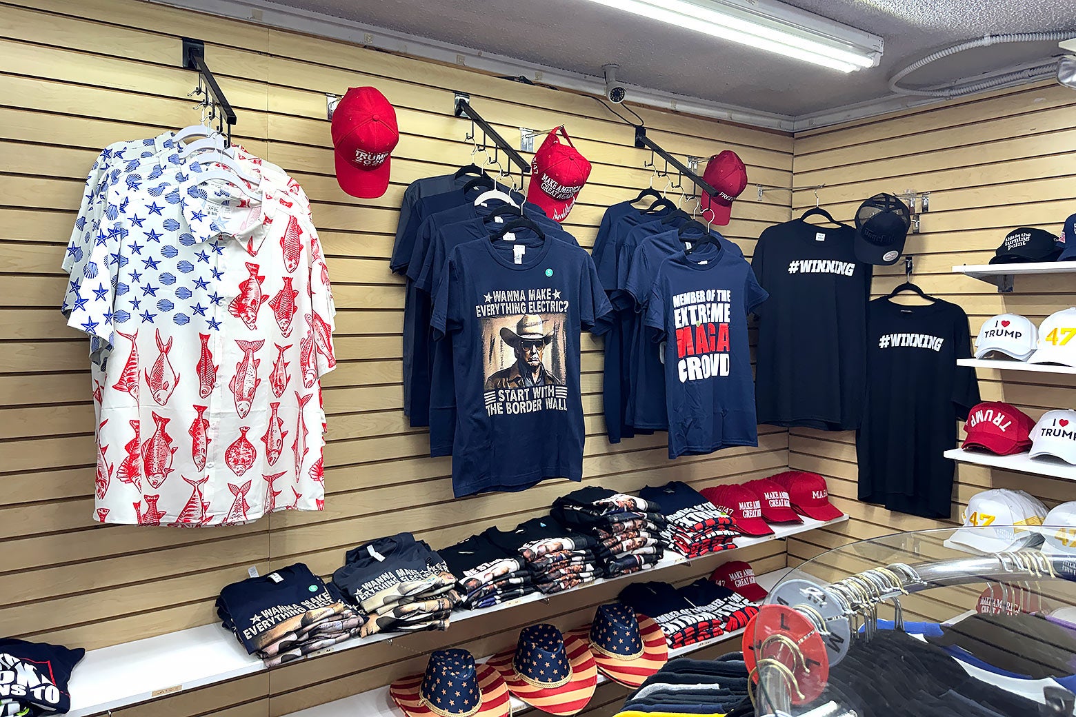 The interior of a retail shop displaying Donald Trump–themed merchandise and other political apparel.