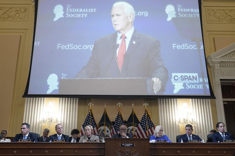 Pence shown on a big screen above a panel of committee members