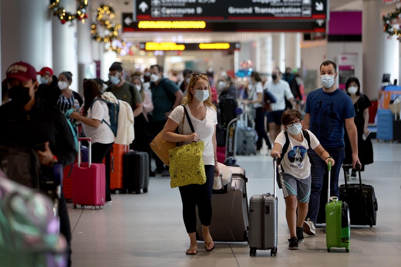 Travelers make their way through Miami International Airport on December 28, 2021 in Miami, Florida. 