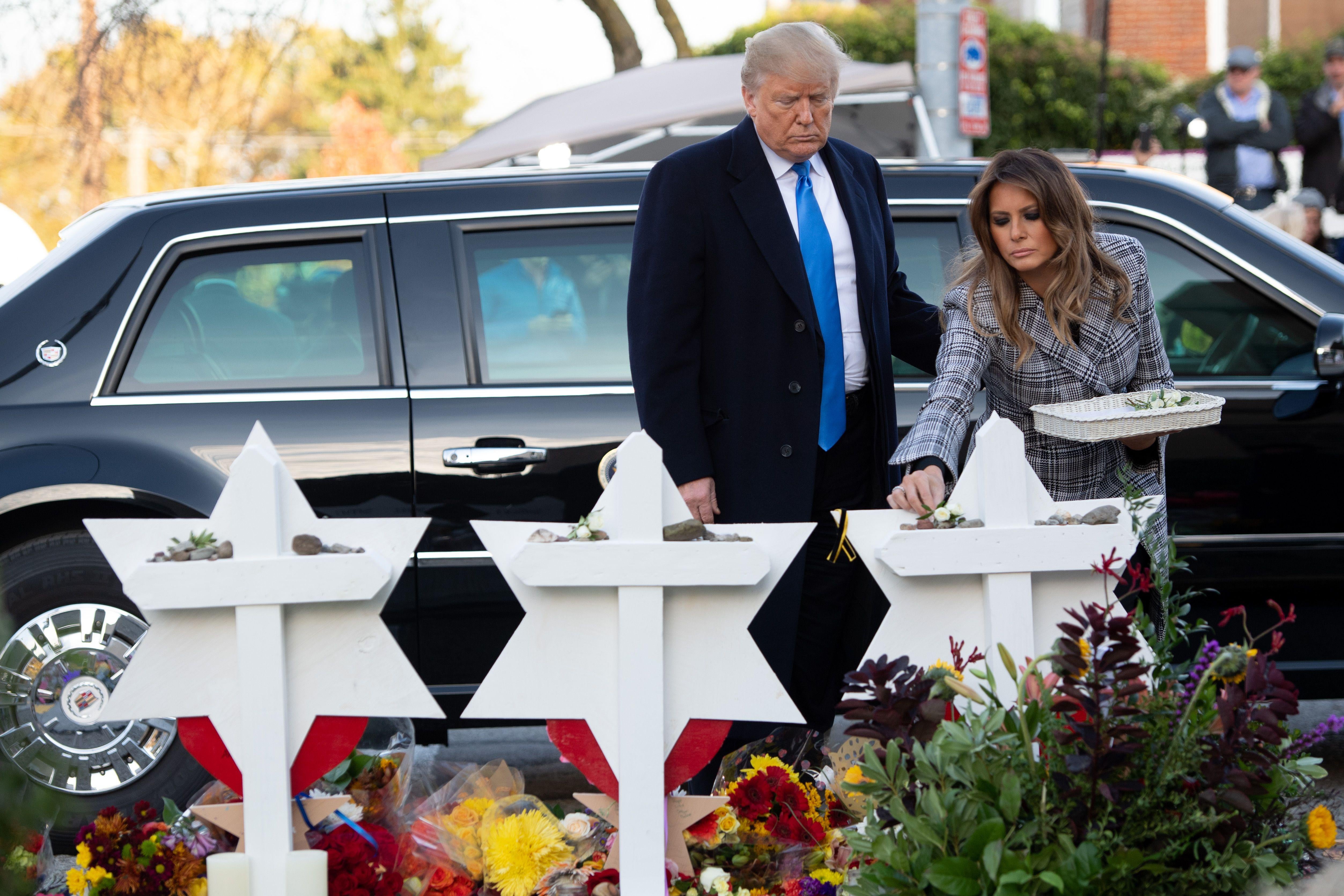 Donald Trump and his wife Melania along with Tree of Life's rabbi Jeffrey Myers, laying stones and flowers at memorials.