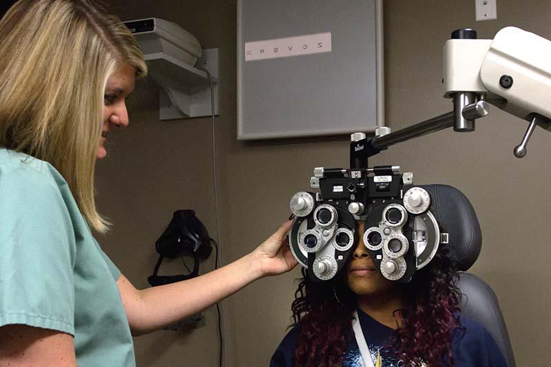 Optometrist Haley Aubrey with a Sarrell Eye patient.
