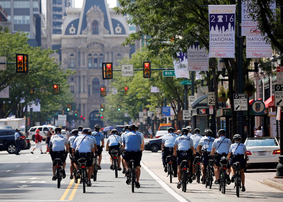 Police ride bicycles down Market Street toward City Hall ahead of the Democratic National Convention in Philadelphia, Pennsylvania, U.S., July 24, 2016. 