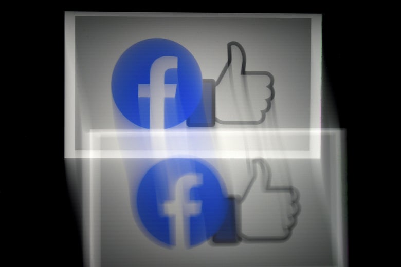 Facebook logo and thumbs-up like icon, blurred.
