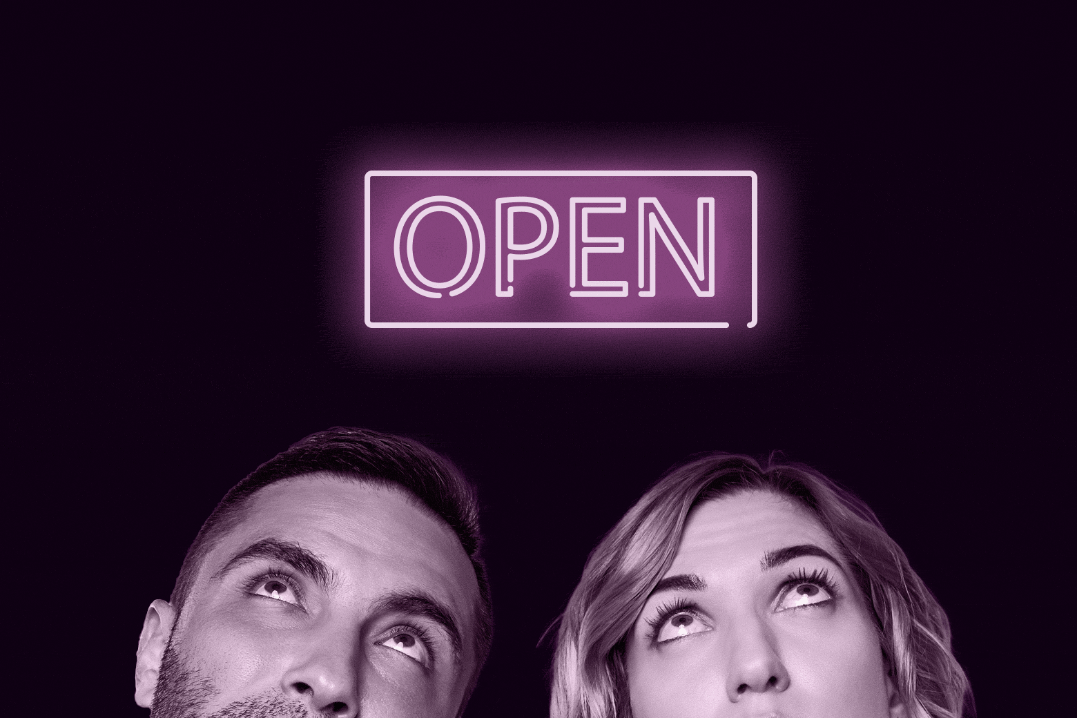 Two people looking up at a sign that says open.