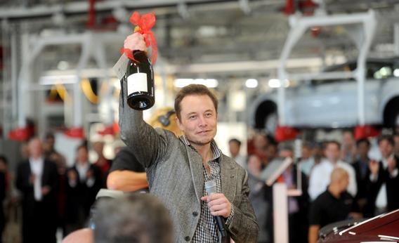 Tesla CEO Elon Musk celebrates at his company's factory in Fremont, Calif., June 22, 2012, as the car company began delivering its Model S electric sedan.