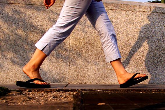 A woman walks with flip flops in Washington, July 15, 2003.