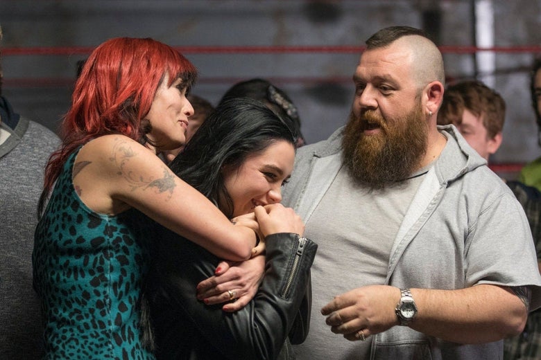 Tattooed Lena Headey, black-haired Florence Pugh, and bearded Nick Frost embrace. In the background, the ropes of a boxing ring.
