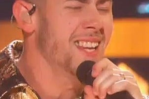 In a zoomed-in shot of Nick Jonas singing at the Grammys, the food in his teeth is even more visible.