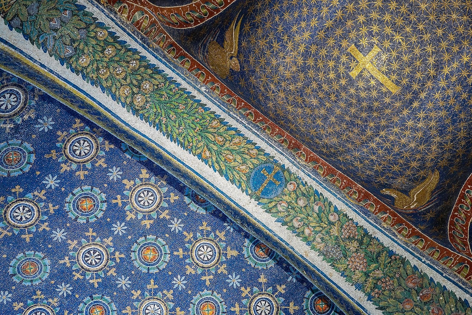 A mosaic ceiling in blue, green, gold, and orange. 