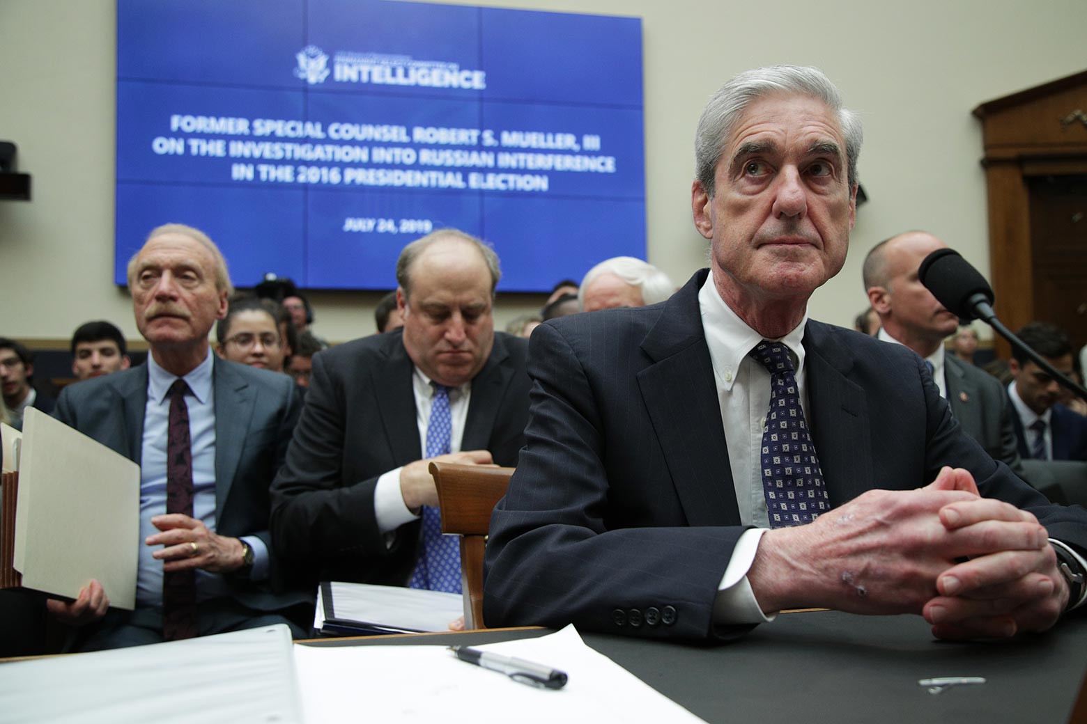 Robert Mueller at a hearing room table. 