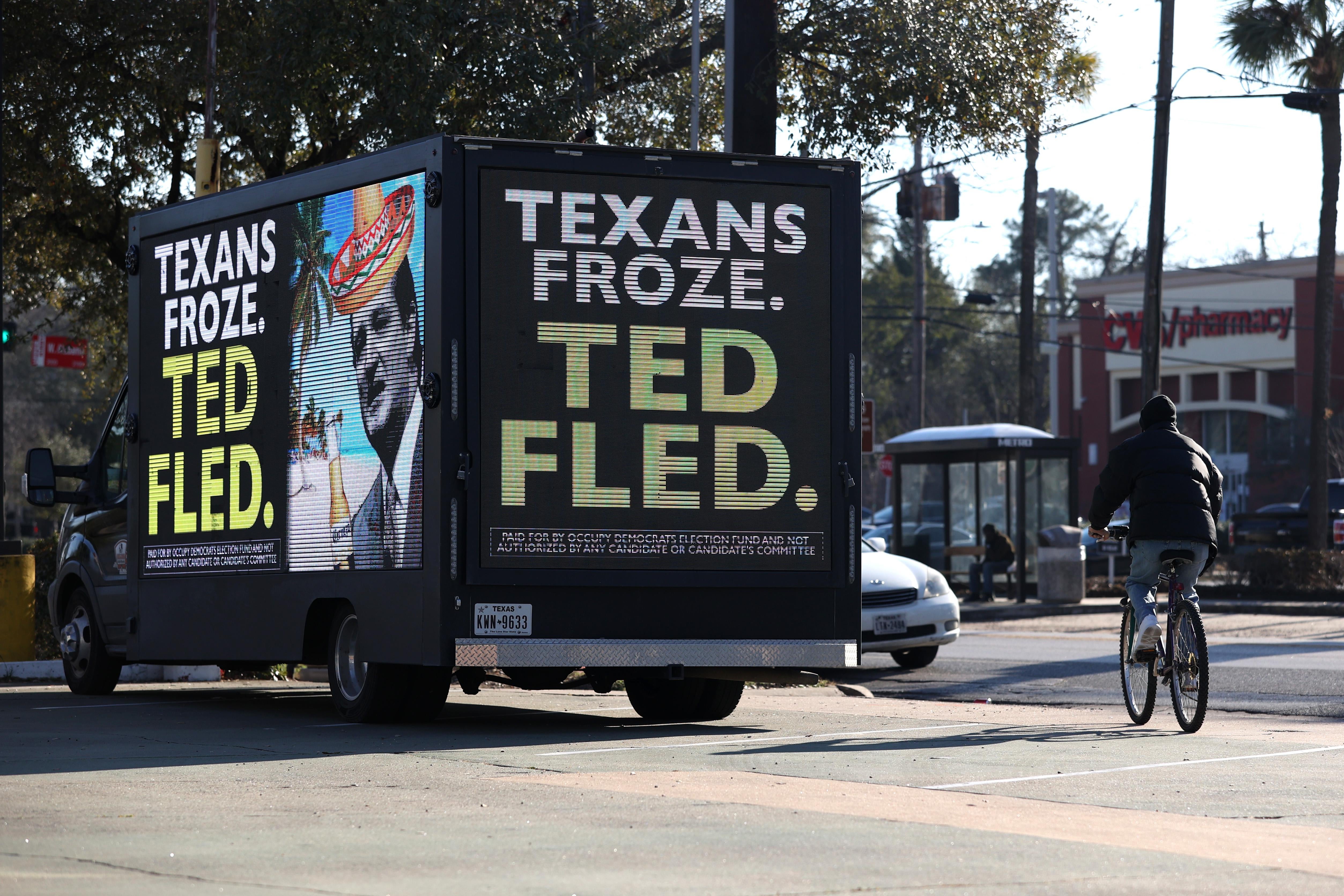 A digital billboard truck features a picture of Ted Cruz in a souvenir sombrero and the text, "TEXAS FROZE. TED FLED."
