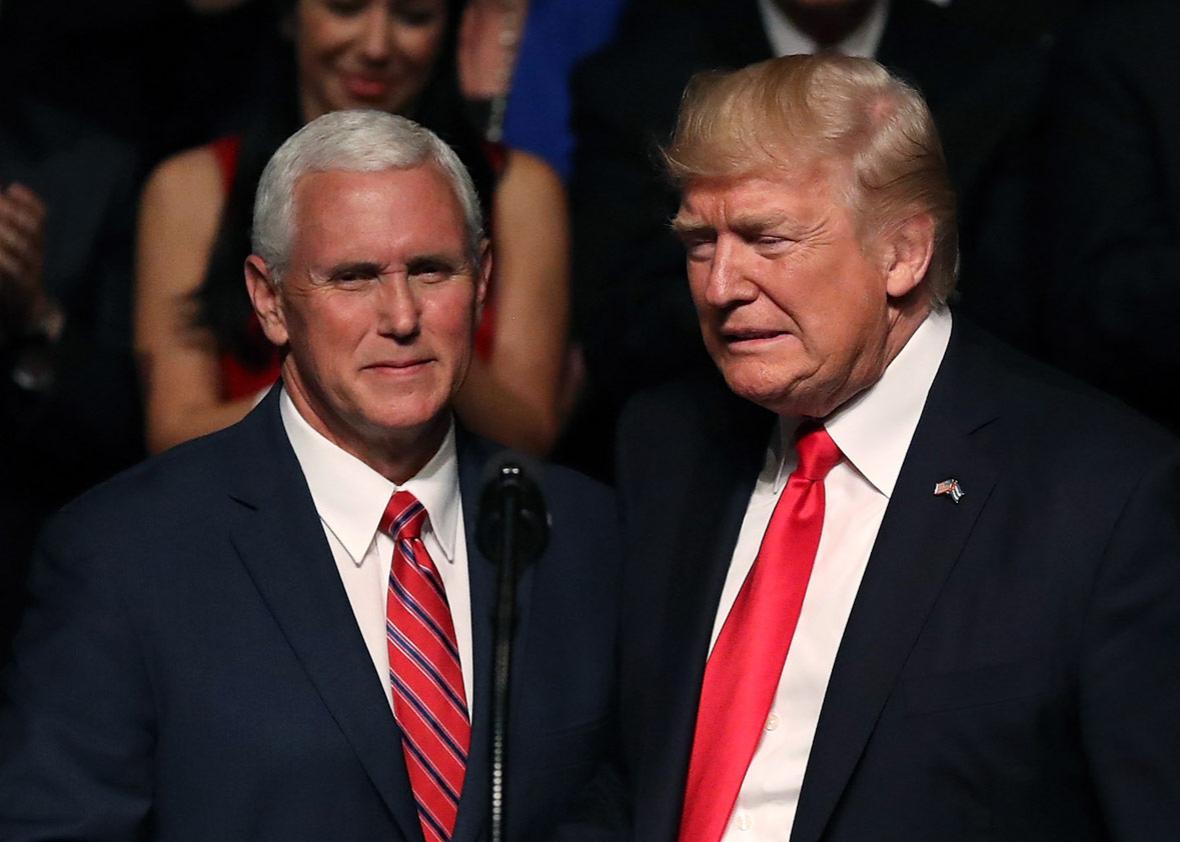 U.S. President Donald Trump (R) is introduced by Vice President Mike Pence