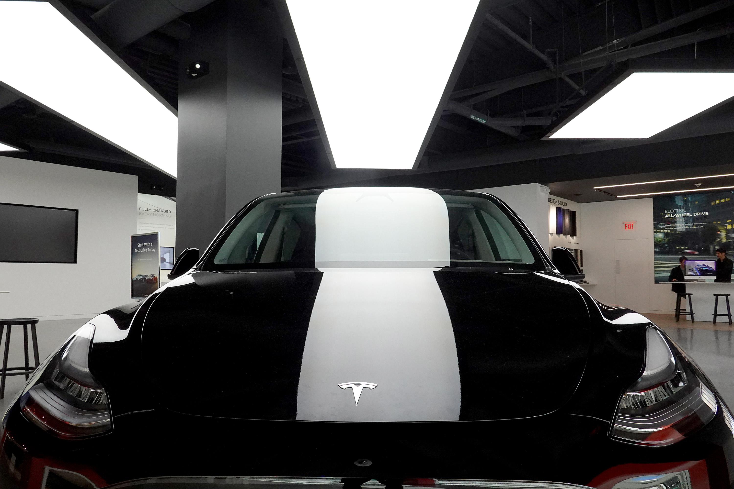 A Tesla Model Y electric vehicle on a showroom floor in Miami