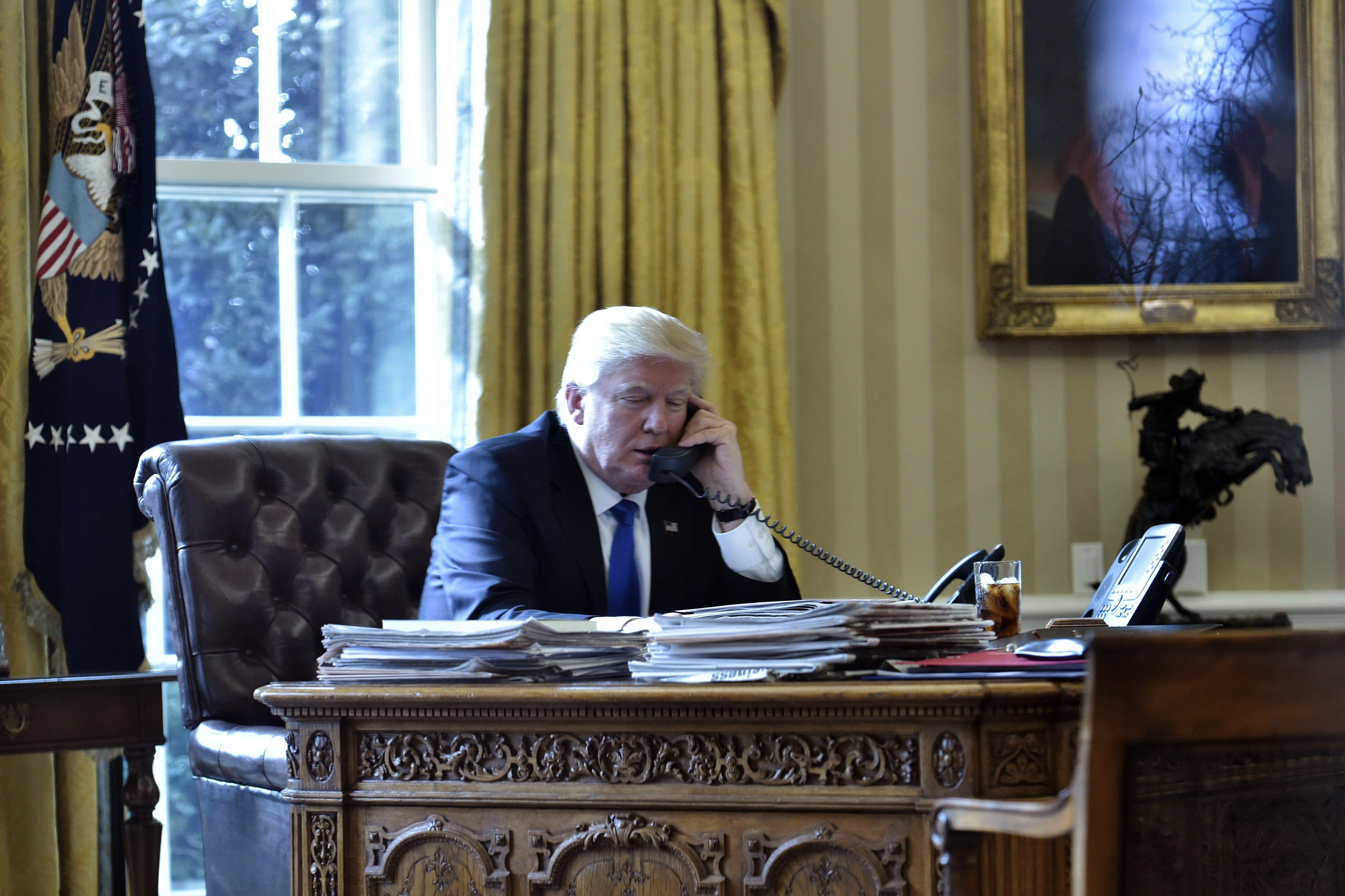 US President Donald Trump speaks on the phone with Russia's President Vladimir Putin from the Oval Office on Jan. 28, 2017