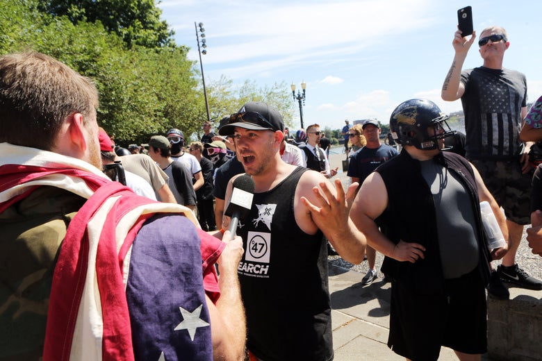 A man is interviewed by Infowars as Joey Gibson speaks at his campaign rally in Portland, Oregon.