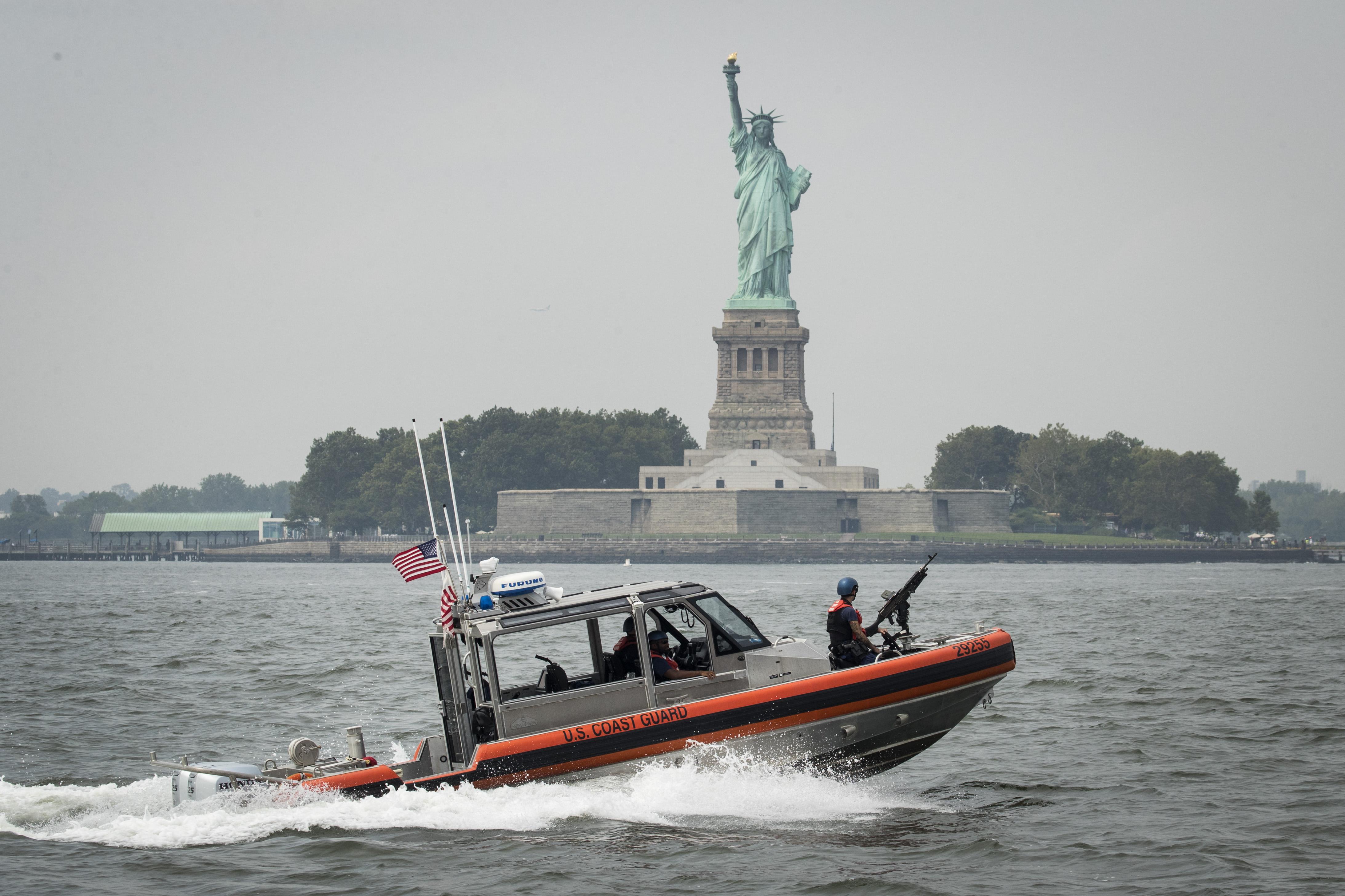 A U.S. Coast Guard boat cruises through New York Harbor near the Statue of Liberty, Aug. 27, 2018.