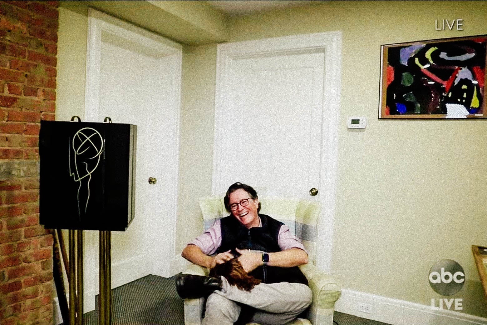 Stephen Colbert sits in a chair at his home during the Emmy Awards.