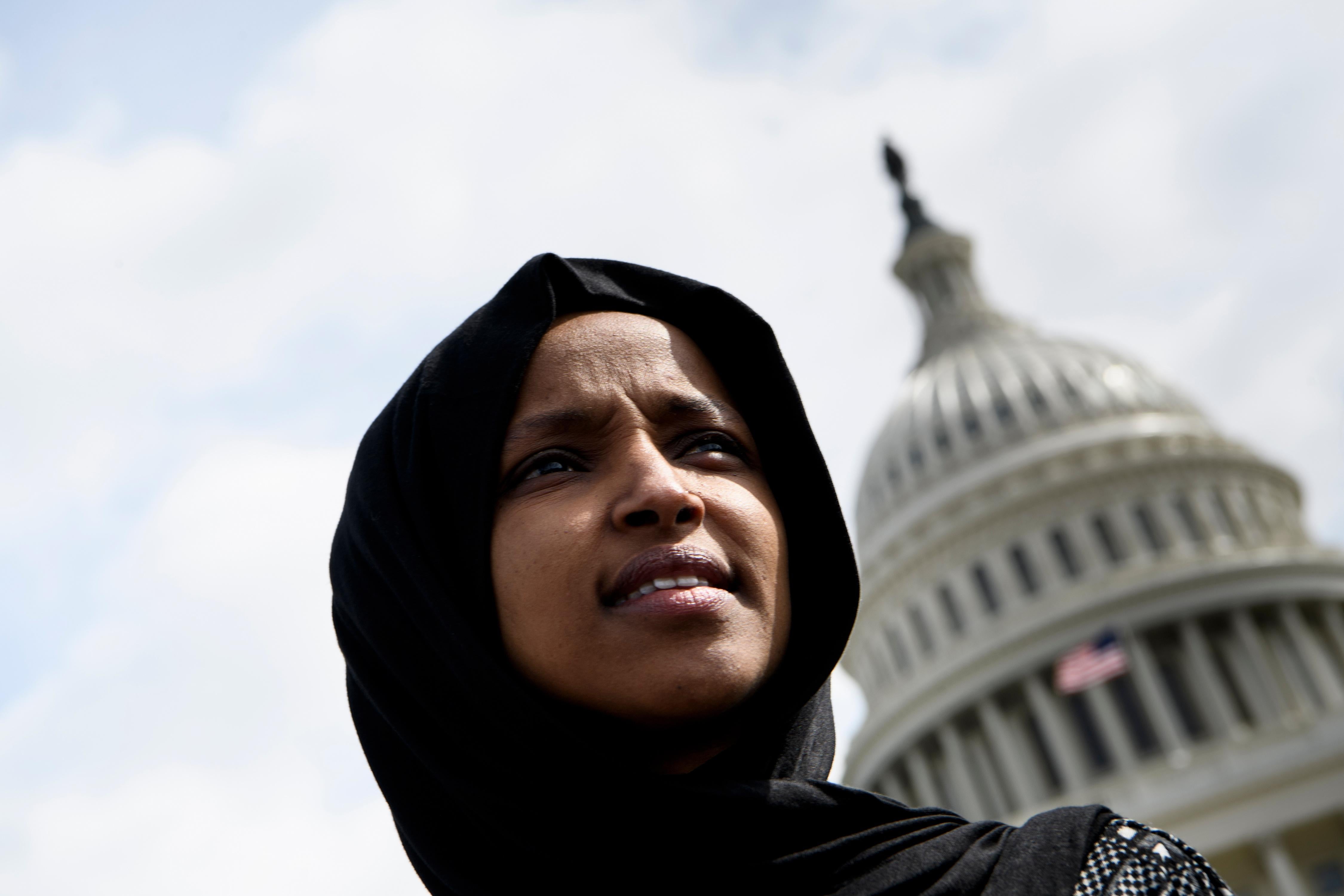 Ilhan Omar standing in front of the Capitol building.