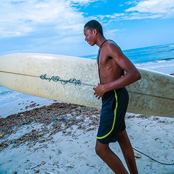 Marco, holding an aptly captioned surfboard, heads down to the water, May 5, 2014.