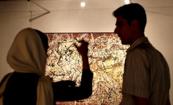Visitors looks at a painting by 20th century U.S. artist Jackson Pollock.