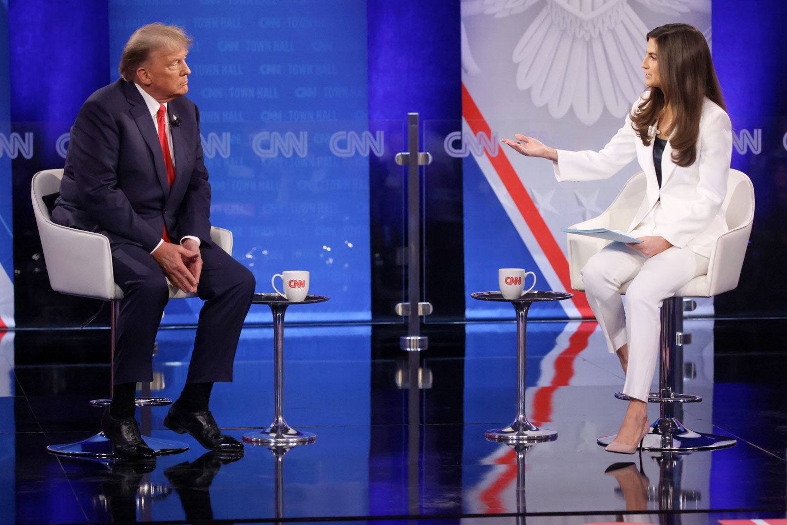 Donald Trump (L) and Kaitlan Collins (R) sit side-by-side onstage at the CNN town hall.