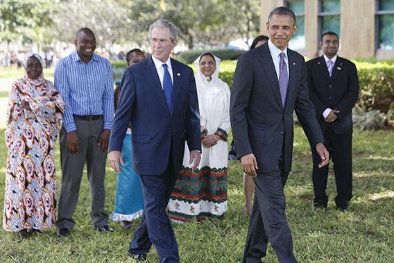 U.S. President Barack Obama (front, R) and former President George W. Bush (front, L) attend a memorial for the victims of the 1998 U.S. Embassy bombing in Dar es Salaam July 2, 2013.\
