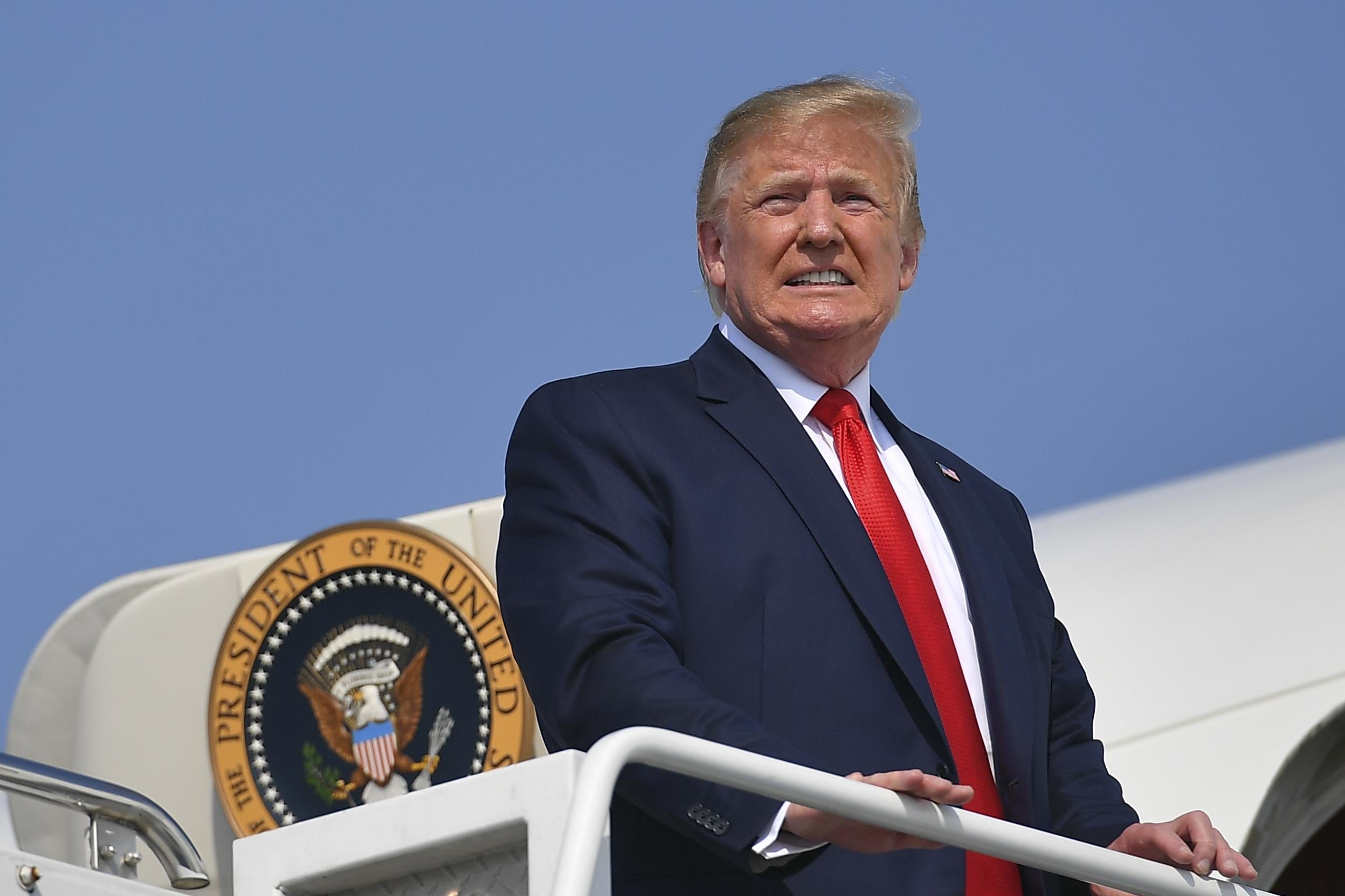 Donald Trump looks into the sun before boarding Air Force One.