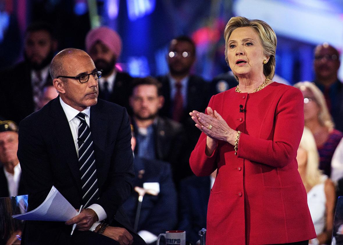 Matt Lauer, co-host of "The Today Show," listens as Democratic presidential nominee Hillary Clinton speaks during a veterans forum at the air and space museum aboard the aircraft carrier USS Intrepid on September 7, 2016 in New York, New York. 