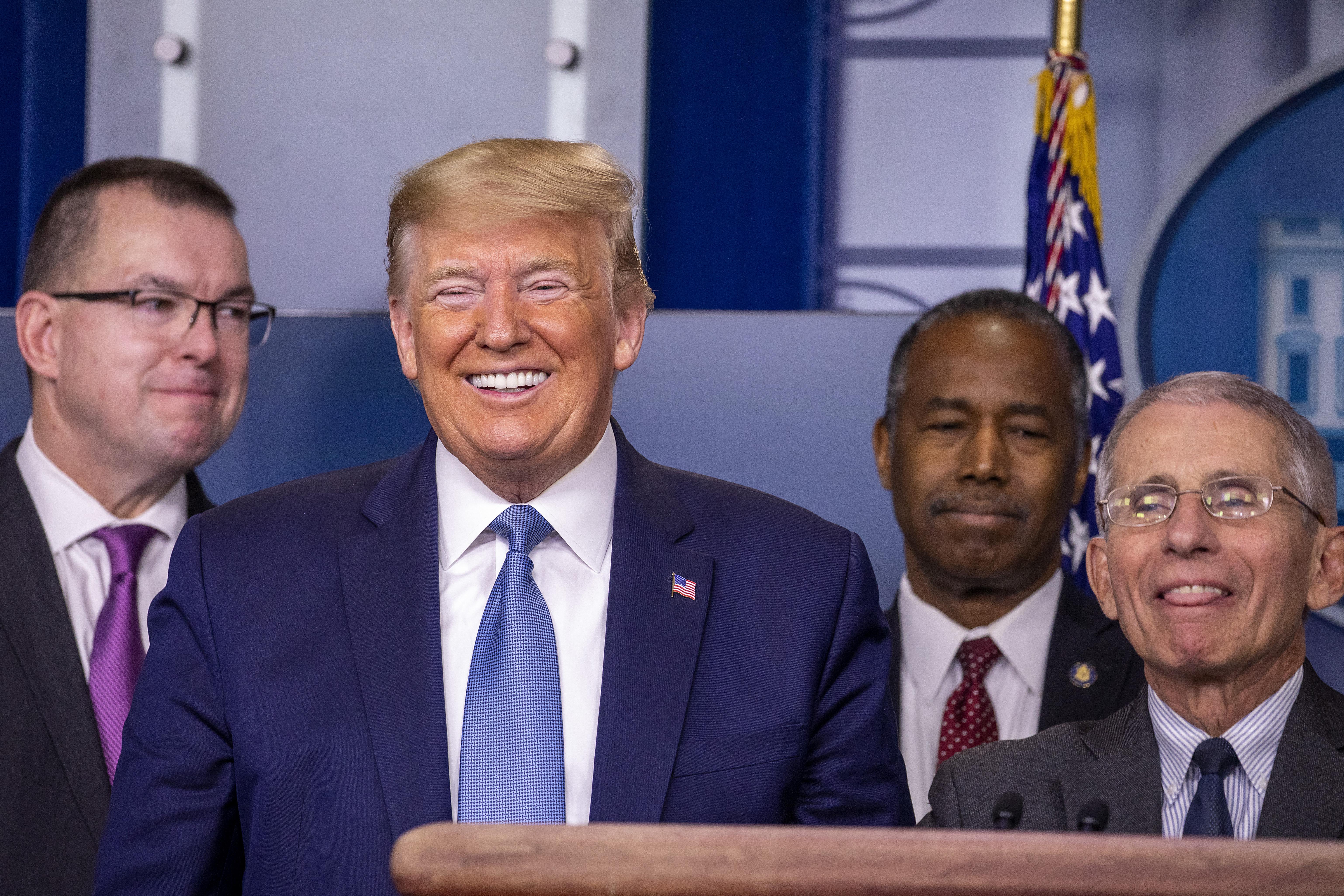 President Donald Trump and Anthony Fauci, Director of the National Institute of Allergy and Infectious Diseases, react to a question during a briefing in the James Brady Press Briefing Room at the White House on March 21, 2020 in Washington, D.C.