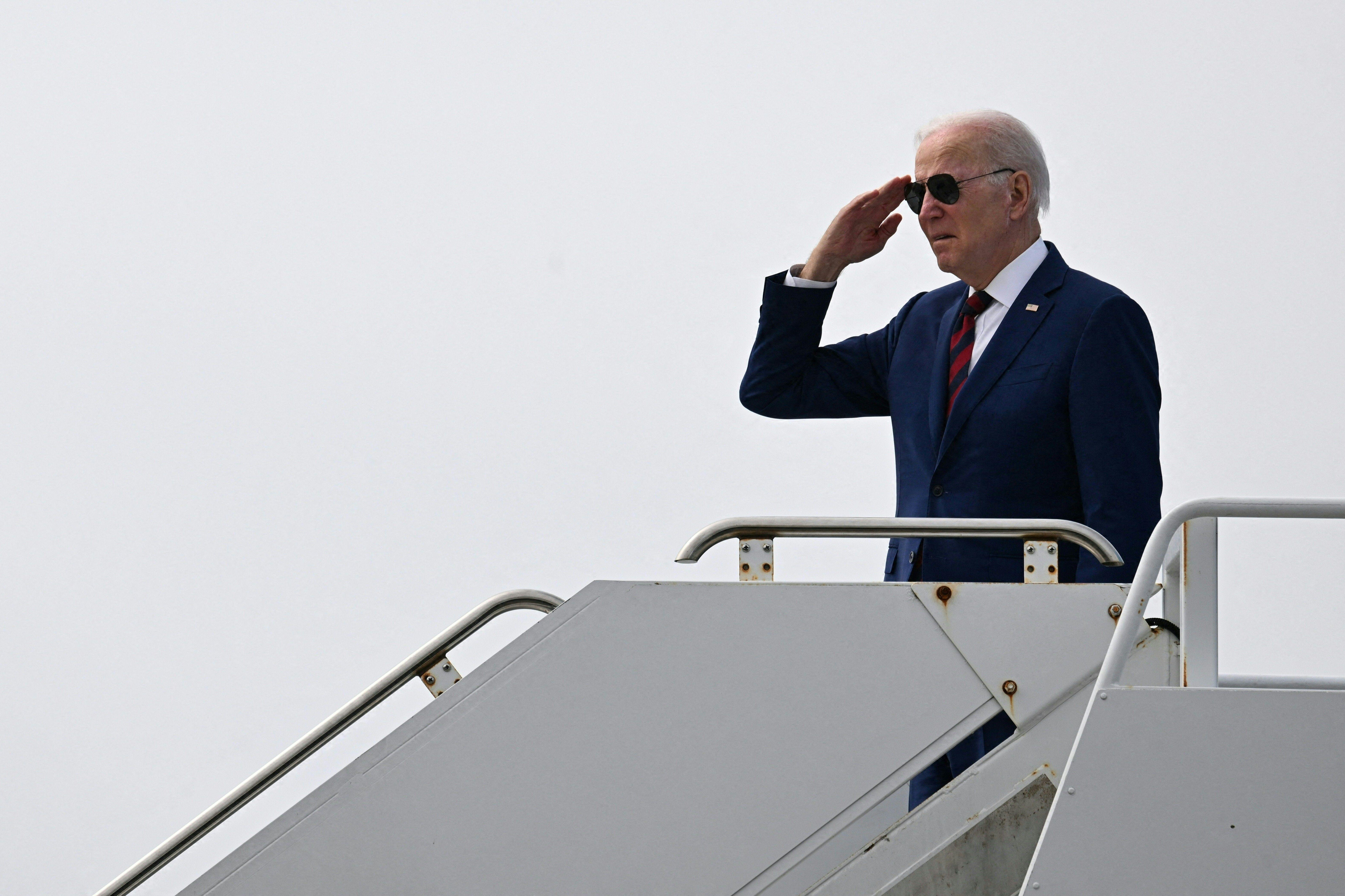  Biden salutes on the stairway to Air Force One.
